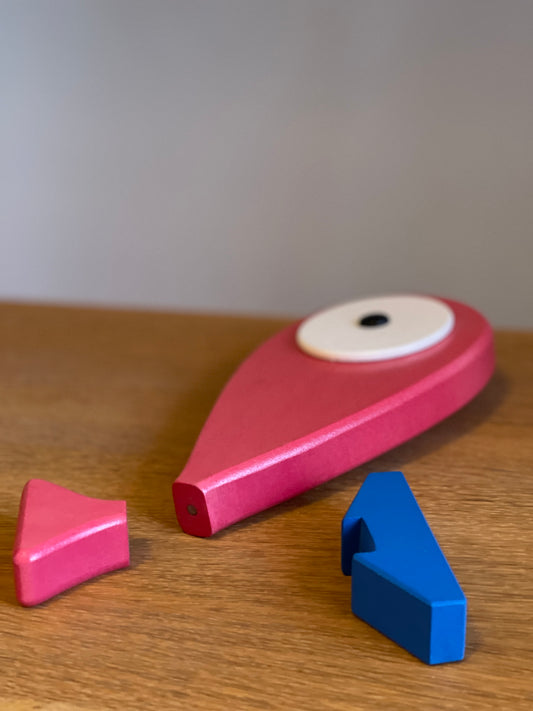 A lovely hand carved and hand painted art toy with a removable magnet tail. Blue stand that represents the ocean and when the fish is placed on the stand it feels like the fish is placed on the top of the water. Detail