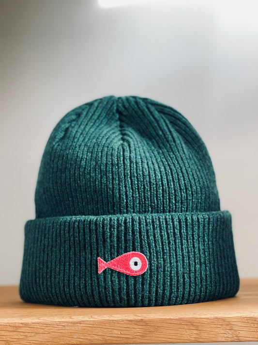 The collection of soft, colorful, and warm beanies crafted from luxurious lambswool yarn. Embrace comfort and style with these lovely accessories available in four captivating colors: Pink, Blue, Vibrant Mint, and Light Grey. Each beanie features a unique fish patch, adding a touch of charm and playfulness. Front