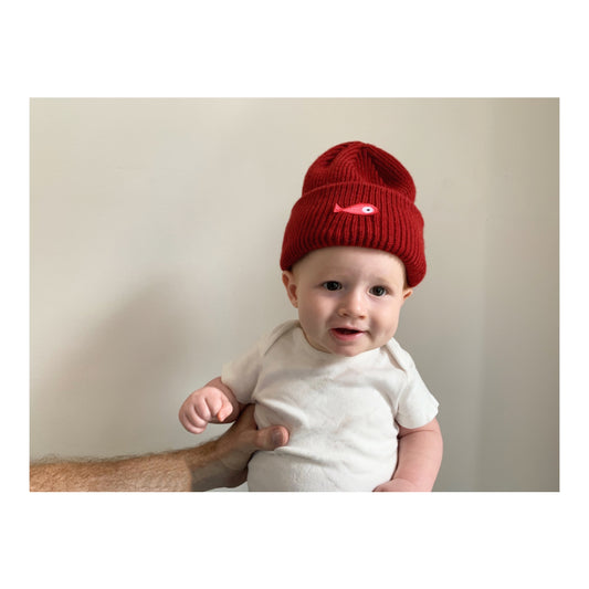 The soft, colorful, and warm kids/baby beanies crafted from luxurious lambswool yarn. Adorned with a playful fish patch for a touch of playfulness. Vibrant palette of six colors – Yellow, Purple, Red, Blue, Pink, and Navy Blue -Fish patch. -One size. Colors: Yellow, Purple, Red, Blue, Pink, Navy Blue Material: 100 % lambswool. Front