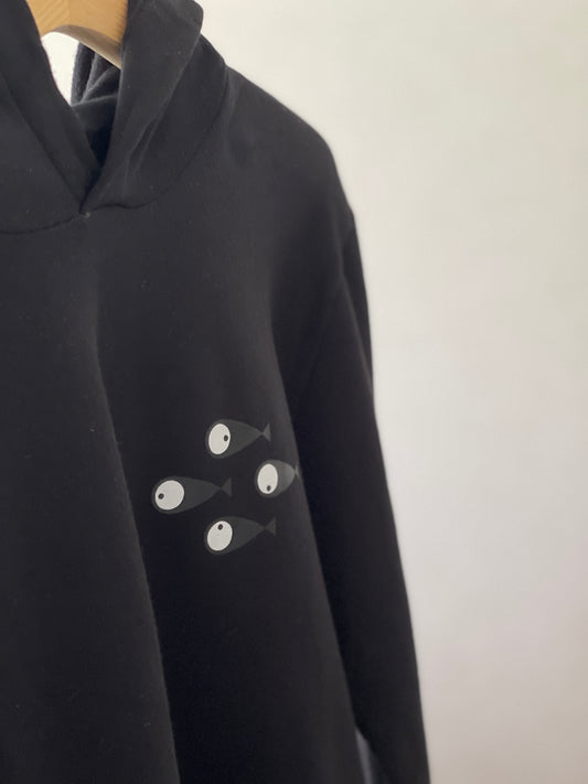 Super cozy hoodie with a kangaroo pocket in the front with no drawstrings. Crafted from 100 % superfine cotton. Raglan sleeves, ribbed trims. The pieces have a pink fish print on front left bottom corner and 4 black fishes print on right chest side. Colour: black Material: 100% cotton