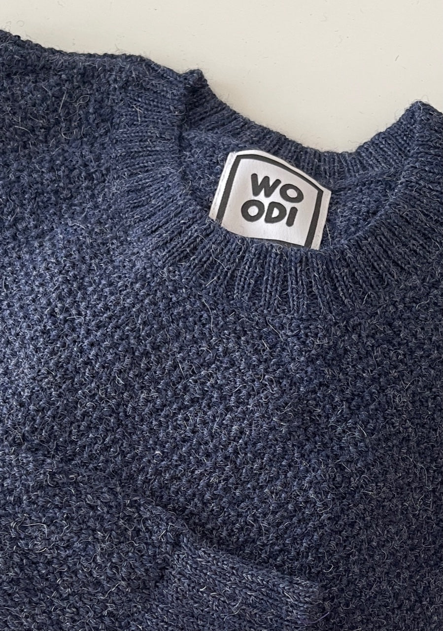 Soft, luxuriously cozy sweater. Knitted from fine alpaca yarn. Classic fit and a lovely feeling. Colours : creme white, navy blue and grey Patch: pink fish ( placed on the right bottom corner ) Material: 100% alpaca Detail Smart casual dress code