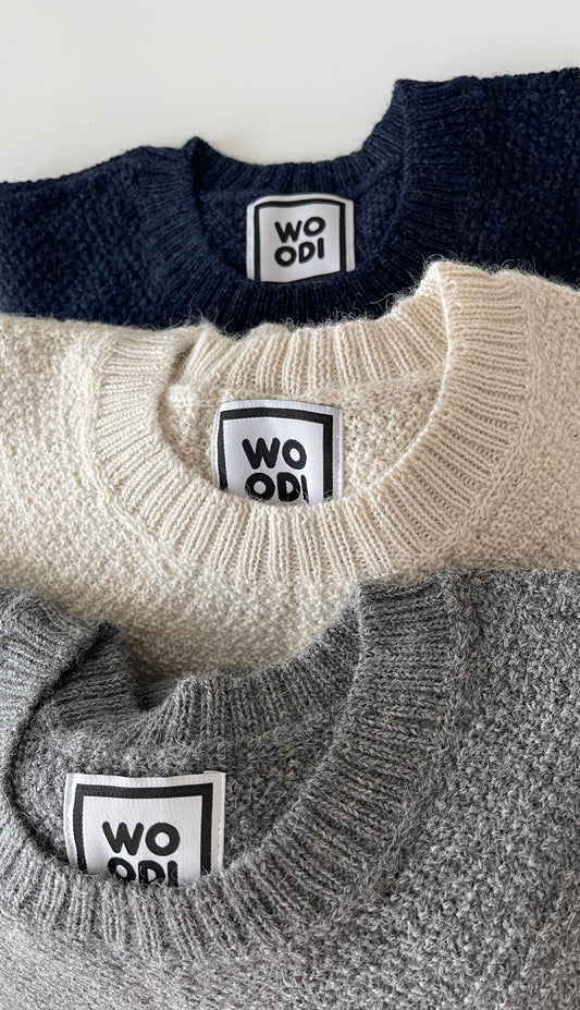 Soft, luxuriously cozy sweater. Knitted from fine alpaca yarn. Classic fit and a lovely feeling. Colours : creme white, navy blue and grey Patch: pink fish ( placed on the right bottom corner ) Material: 100% alpaca Detail Smart casual dress code