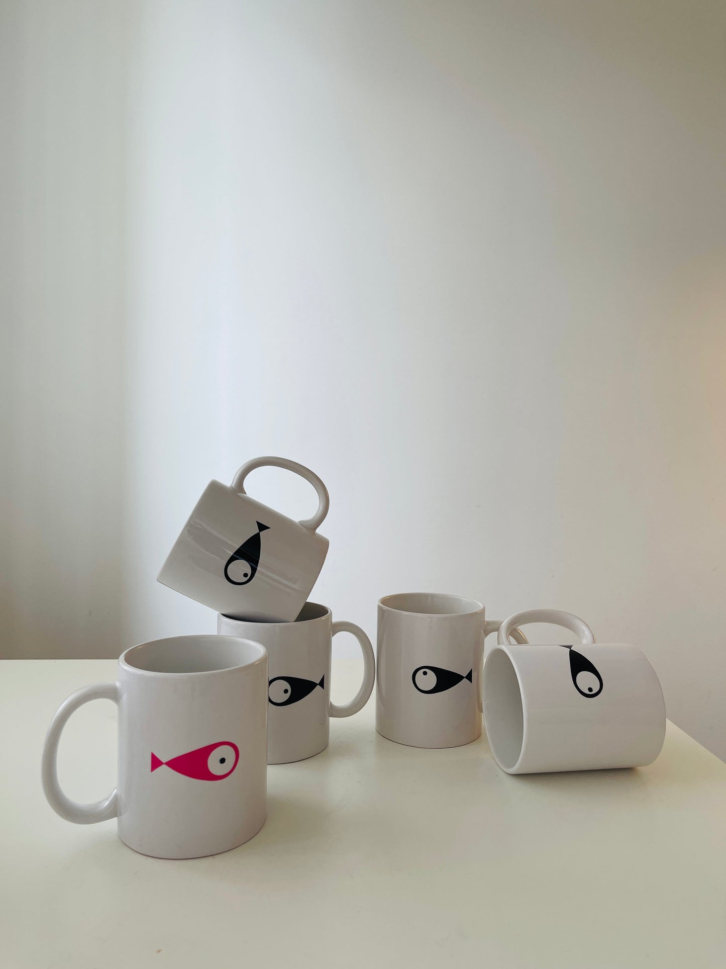WOODI 5 Fishes Mugs  Set of 5  Porcelain&nbsp;mug&nbsp;features large handle  Illustration on every mug with each&nbsp;fish looking at a different direction  Perfect for enjoying a cup of coffee or tea  Dimensions (height): 9 cm  Diameter: 8 cm  Dishwasher safe but hand washing suggested