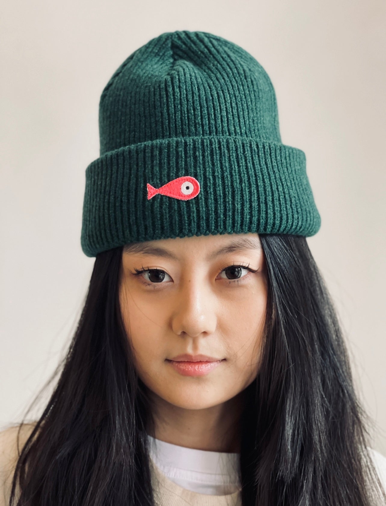 The collection of soft, colorful, and warm beanies crafted from luxurious lambswool yarn. Embrace comfort and style with these lovely accessories available in four captivating colors: Pink, Blue, Vibrant Mint, and Light Grey. Each beanie features a unique fish patch, adding a touch of charm and playfulness.  Front