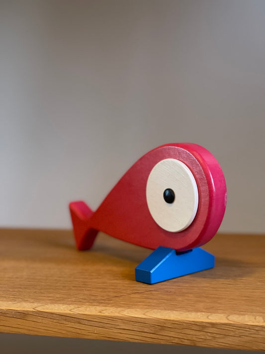 A lovely hand carved and hand painted art toy with a removable magnet tail. Blue stand that represents the ocean and when the fish is placed on the stand it feels like the fish is placed on the top of the water. Front Side