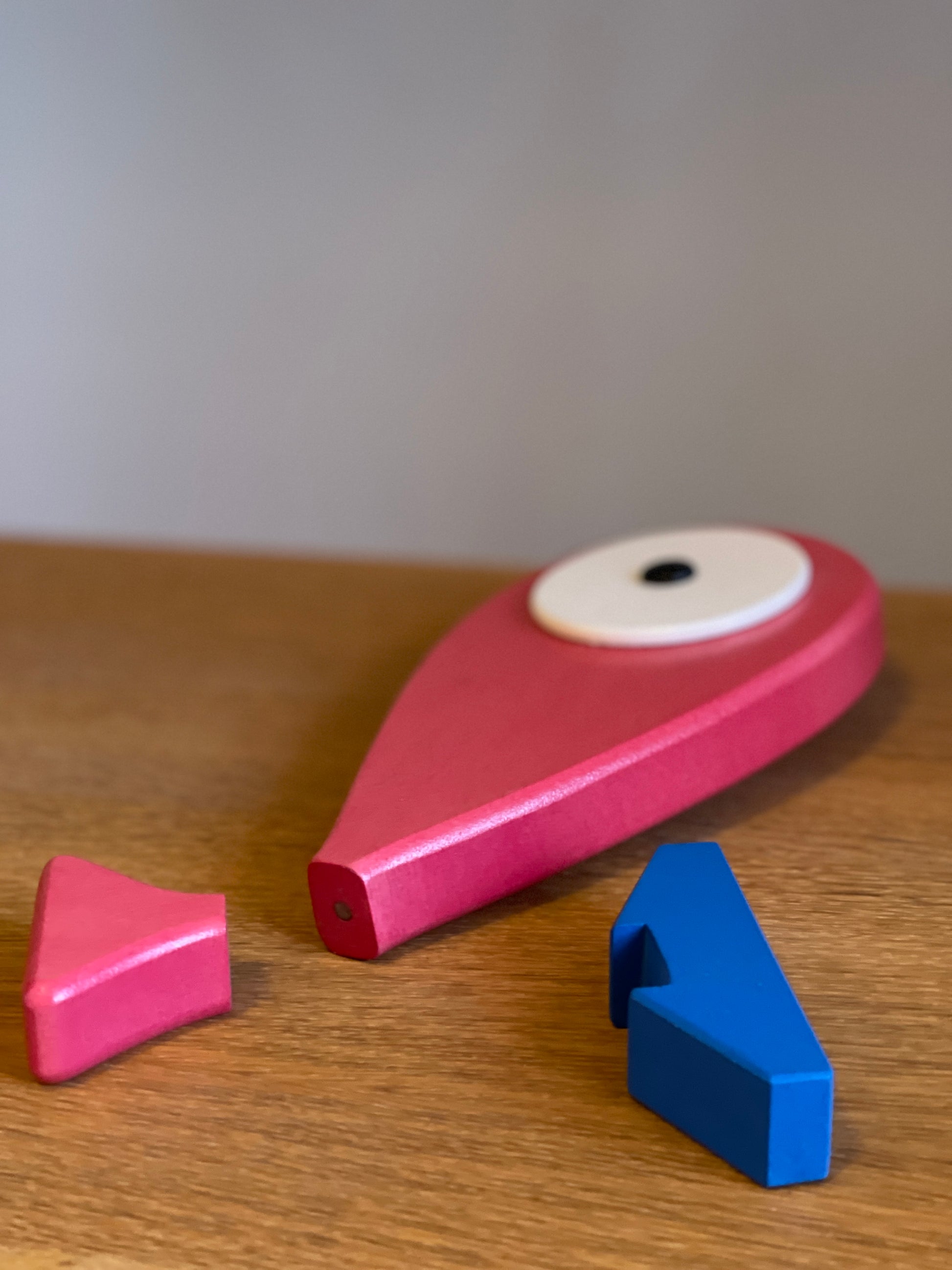 A lovely hand carved and hand painted art toy with a removable magnet tail. Blue stand that represents the ocean and when the fish is placed on the stand it feels like the fish is placed on the top of the water. Detail