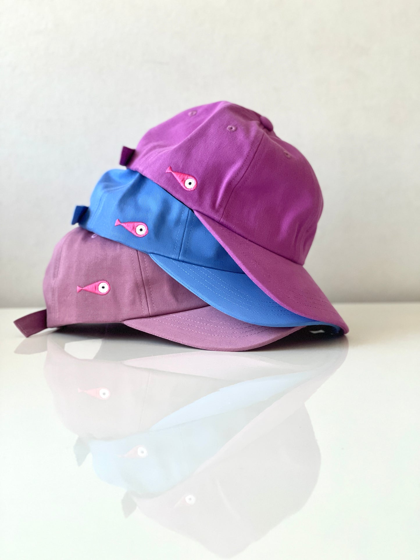 Cap Classic "Fish"  Slightly curved brim  Fish embroidery on the side  Label on the back  Buckle to adjust the fit  3 Colors available :   Light Blue  Grape Purple ( darker color than the sweet potato purple )  Sweet Potato Purple ( lighter color than the grape purple )  100 % cotton  One size