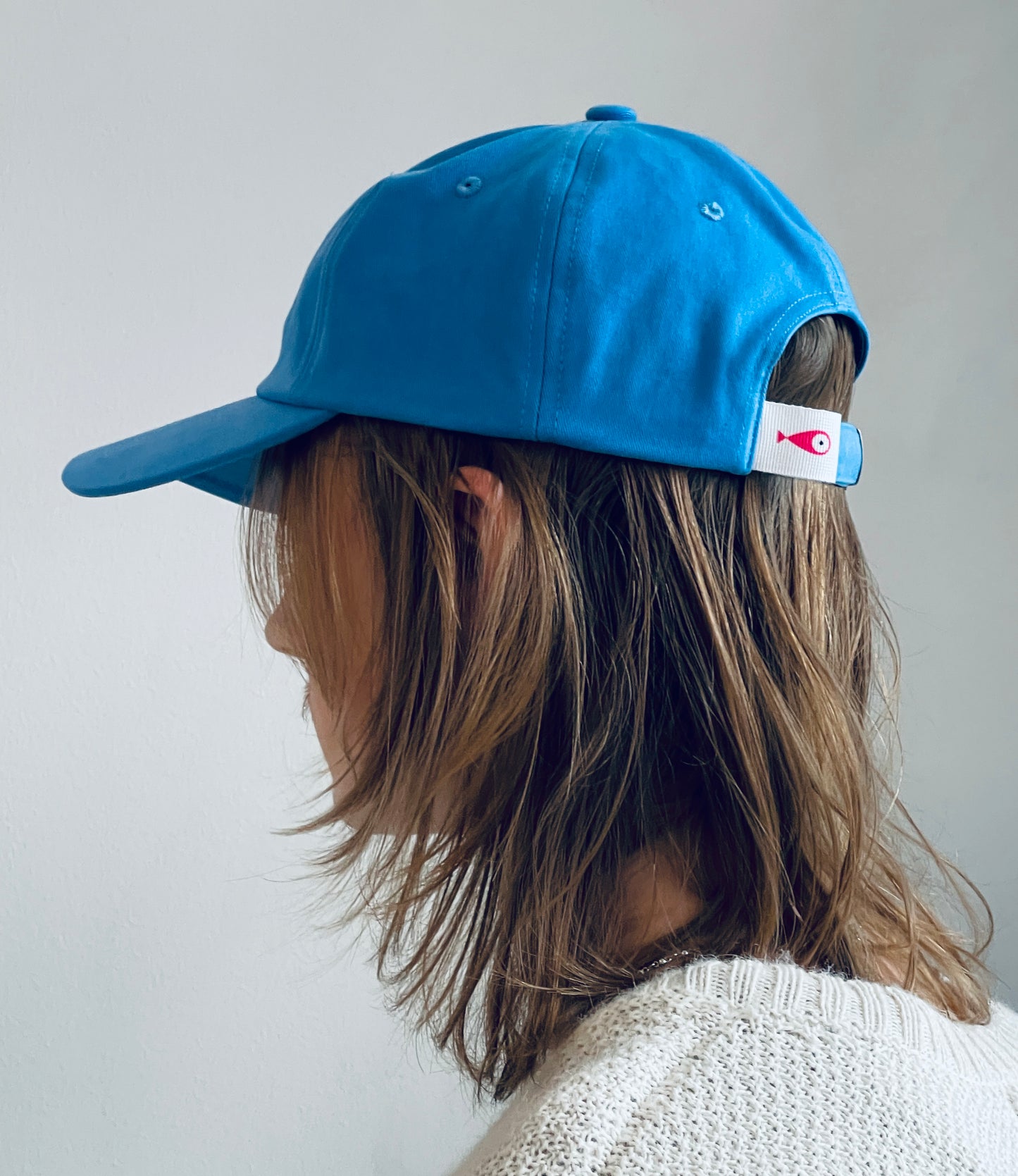 Cap Classic "Fish"  Slightly curved brim  Fish embroidery on the side  Label on the back  Buckle to adjust the fit  3 Colors available :   Light Blue  Grape Purple ( darker color than the sweet potato purple )  Sweet Potato Purple ( lighter color than the grape purple )  100 % cotton  One size Back Side