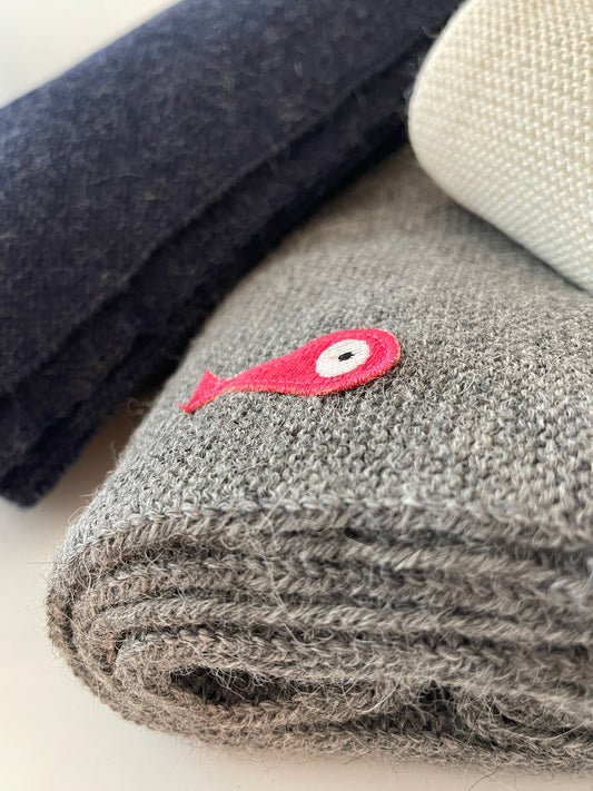 Soft, luxuriously and cozy scarfs. Knitted from a superfine alpaca yarn. Classic scarfs with a lovely feeling.  Colours : creme white, navy blue and grey  Material: 100% alpaca  Patch: pink fish  Sizes:  Navy Blue color : 2.20 cm x 22 cm  Grey color : 2.20 cm x 22 cm   Creme White color :  200 cm x 22 cm Detail Smart casual dress code