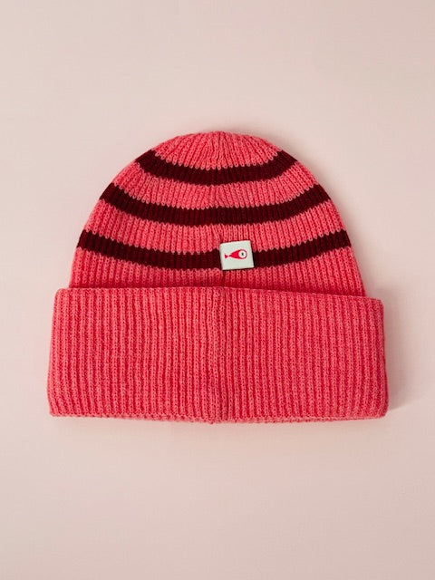 The collection of soft, colorful, and warm beanies crafted from luxurious lambswool yarn. Embrace comfort and style with these lovely accessories available in two lovely colors: Pink with red stripes and Navy blue with lighter blue stripes. Front