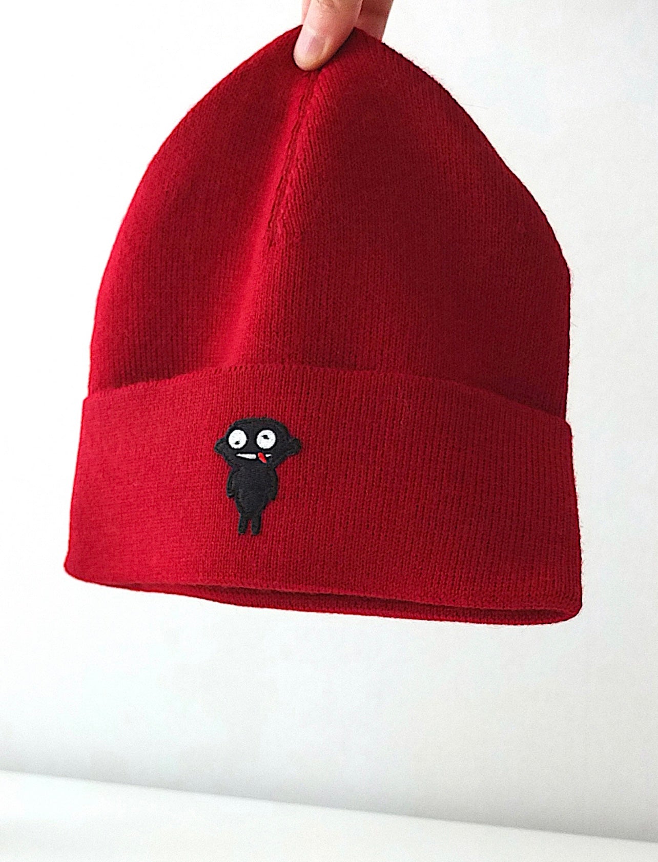 Beanie teddy is designed for both style and functionality. Crafted from luxurious alpaca yarn, these beanies offer an unparalleled level of warmth and comfort.  The tight-fitting design ensures a snug and cozy feel, while the high top provides extra coverage against chilly weather. The addition of a charming teddy patch adds a playful touch.  Available in Black and vibrant Red color, these beanies not only style but also the ultimate in comfort and quality. Front