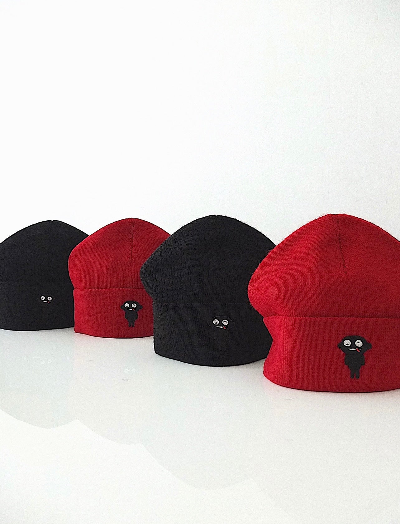 Beanie teddy is designed for both style and functionality. Crafted from luxurious alpaca yarn, these beanies offer an unparalleled level of warmth and comfort.  The tight-fitting design ensures a snug and cozy feel, while the high top provides extra coverage against chilly weather. The addition of a charming teddy patch adds a playful touch.  Available in Black and vibrant Red color, these beanies not only style but also the ultimate in comfort and quality. Front Side