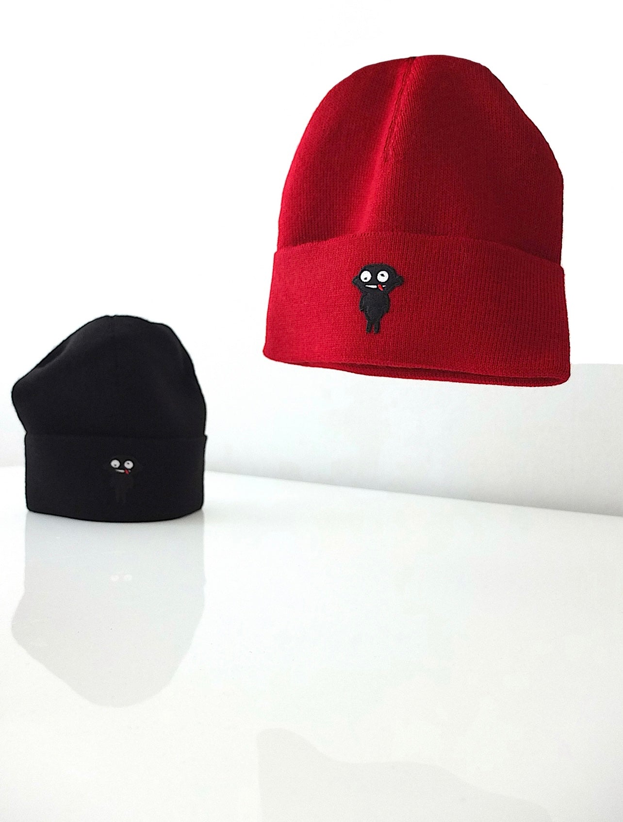 Beanie teddy is designed for both style and functionality. Crafted from luxurious alpaca yarn, these beanies offer an unparalleled level of warmth and comfort.  The tight-fitting design ensures a snug and cozy feel, while the high top provides extra coverage against chilly weather. The addition of a charming teddy patch adds a playful touch.  Available in Black and vibrant Red color, these beanies not only style but also the ultimate in comfort and quality. Front