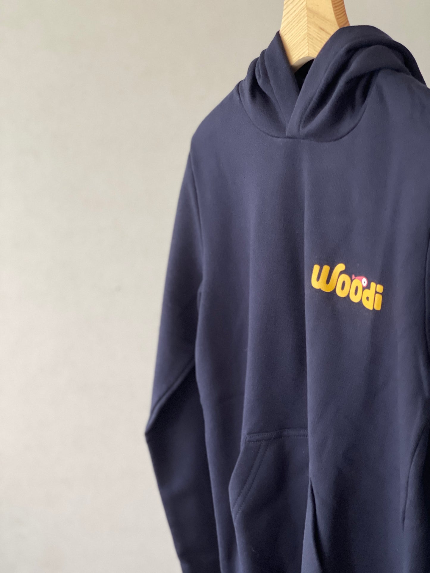 Super cozy hoodie with a kangaroo pocket in the front with no drawstrings. Crafted from the finest cotton. Raglan sleeves, ribbed trims. The pieces have a WOODI swirl text and fish print in the front.  Colour: navy blue Material: 100% cotton