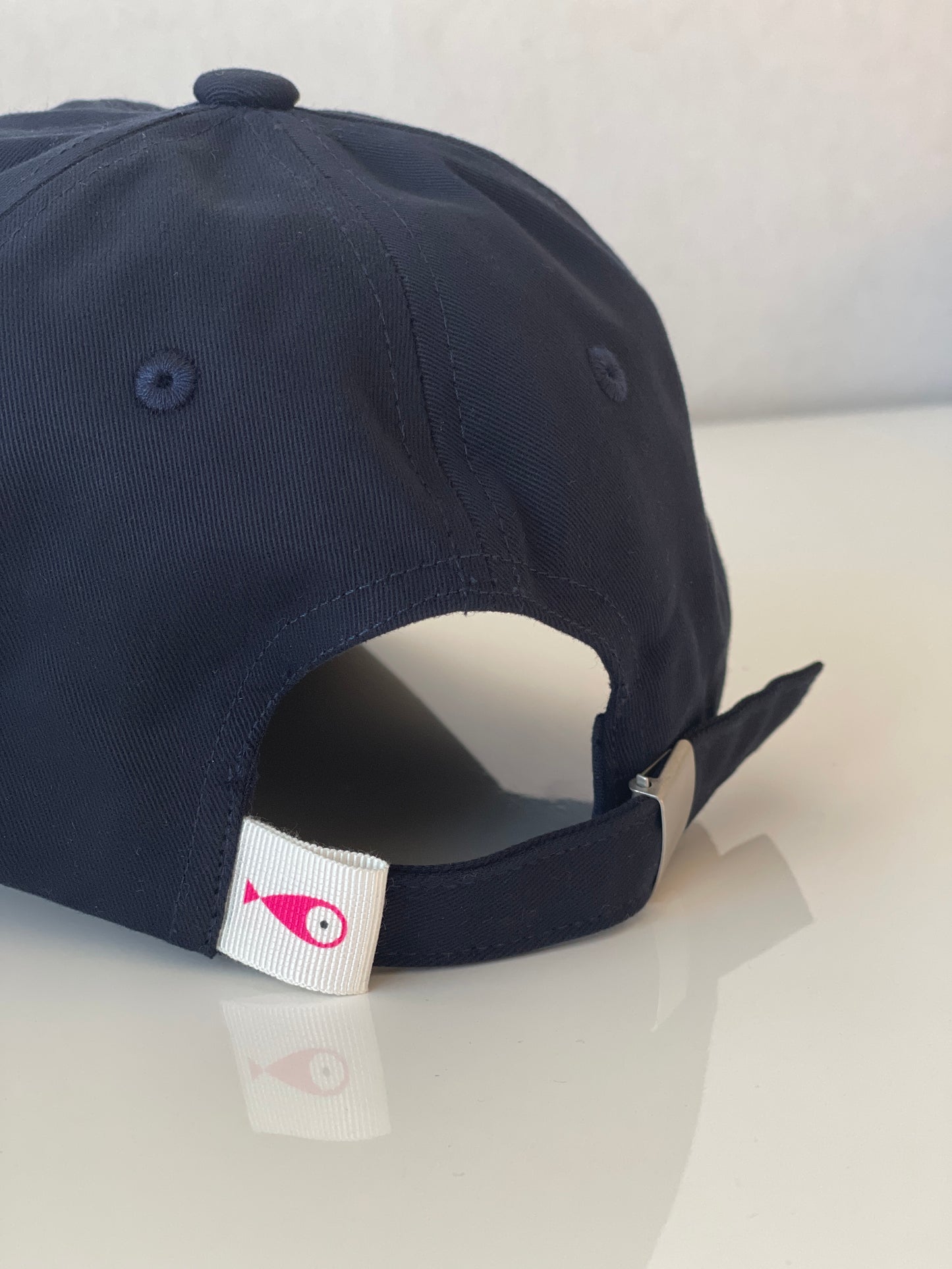 Cap Classic "Fish"  Slightly curved brim  Fish embroidery on front  Label on the back  Buckle to adjust the fit  5 Colors available : Navy Blue, Black, Pink, Olive Green and Light Beige  100 % cotton  One size  Back