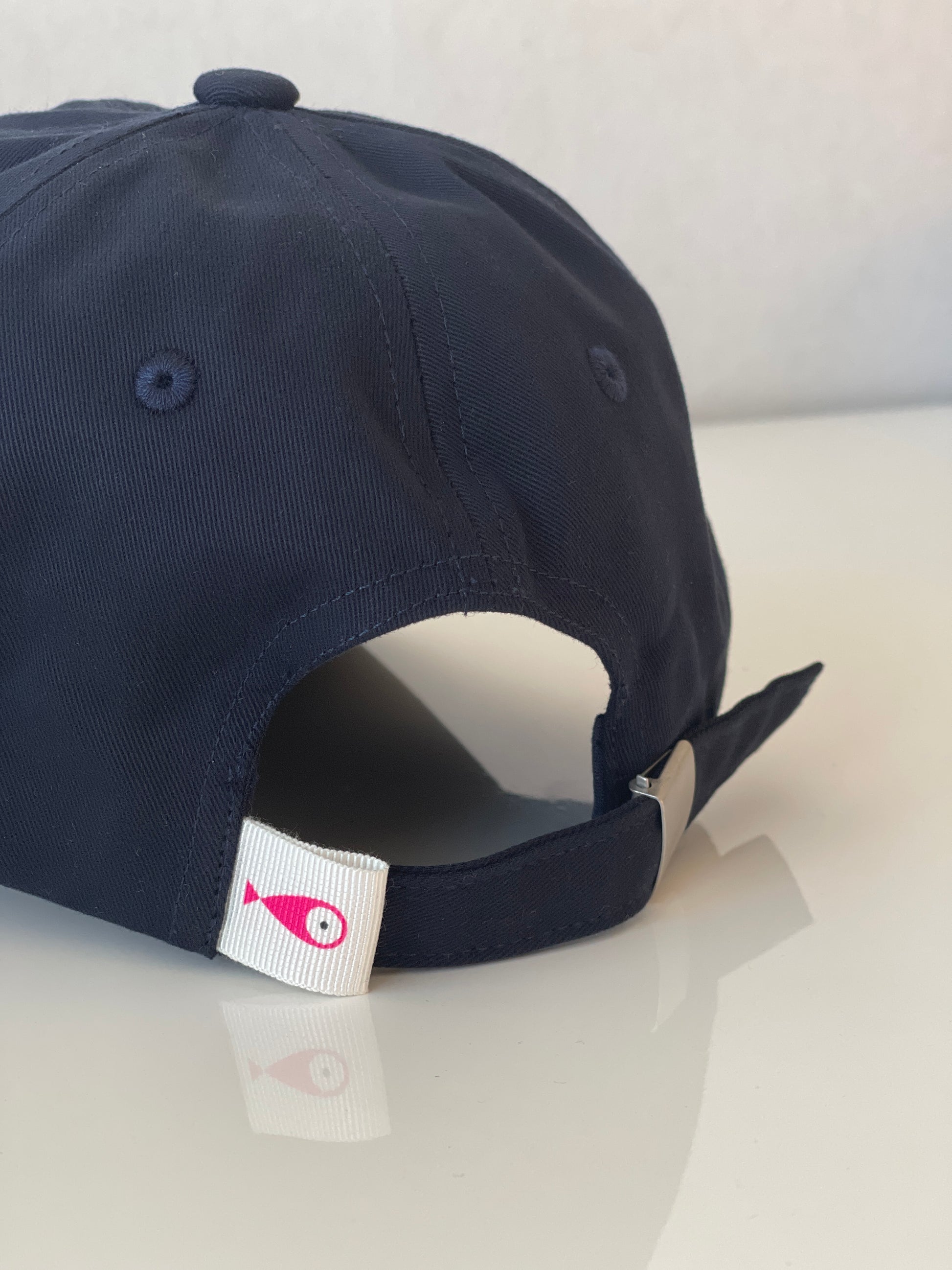 Cap Classic "Fish"  Slightly curved brim  Fish embroidery on front  Label on the back  Buckle to adjust the fit  5 Colors available : Navy Blue, Black, Pink, Olive Green and Light Beige  100 % cotton  One size  Back