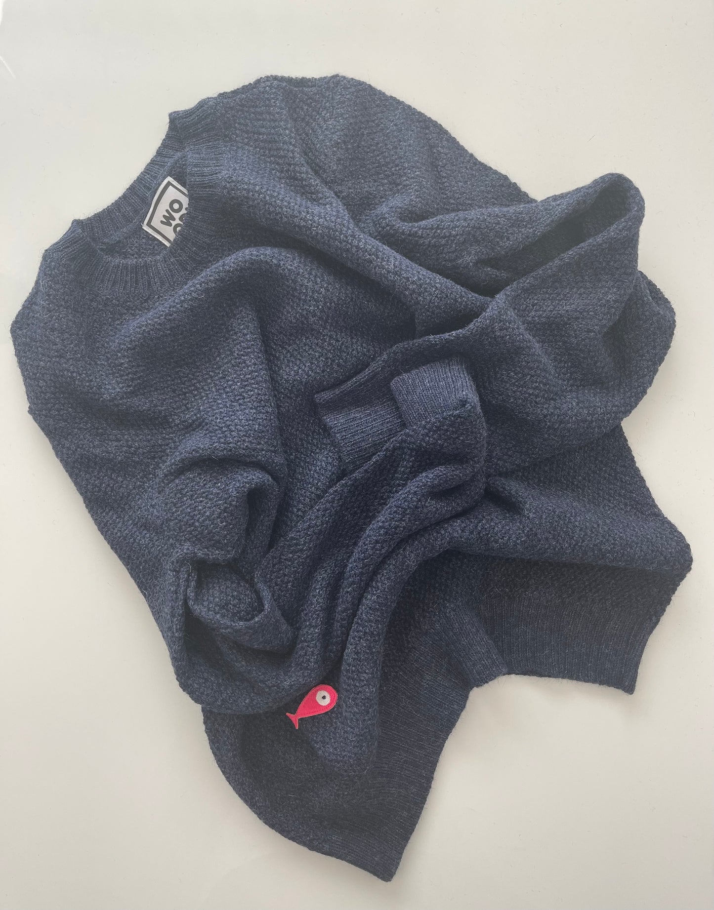 Soft, luxuriously cozy sweater. Knitted from fine alpaca yarn. Classic fit and a lovely feeling.  Colours : creme white, navy blue and grey  Patch: pink fish ( placed on the right bottom corner )  Material: 100% alpaca Front Smart casual dress code