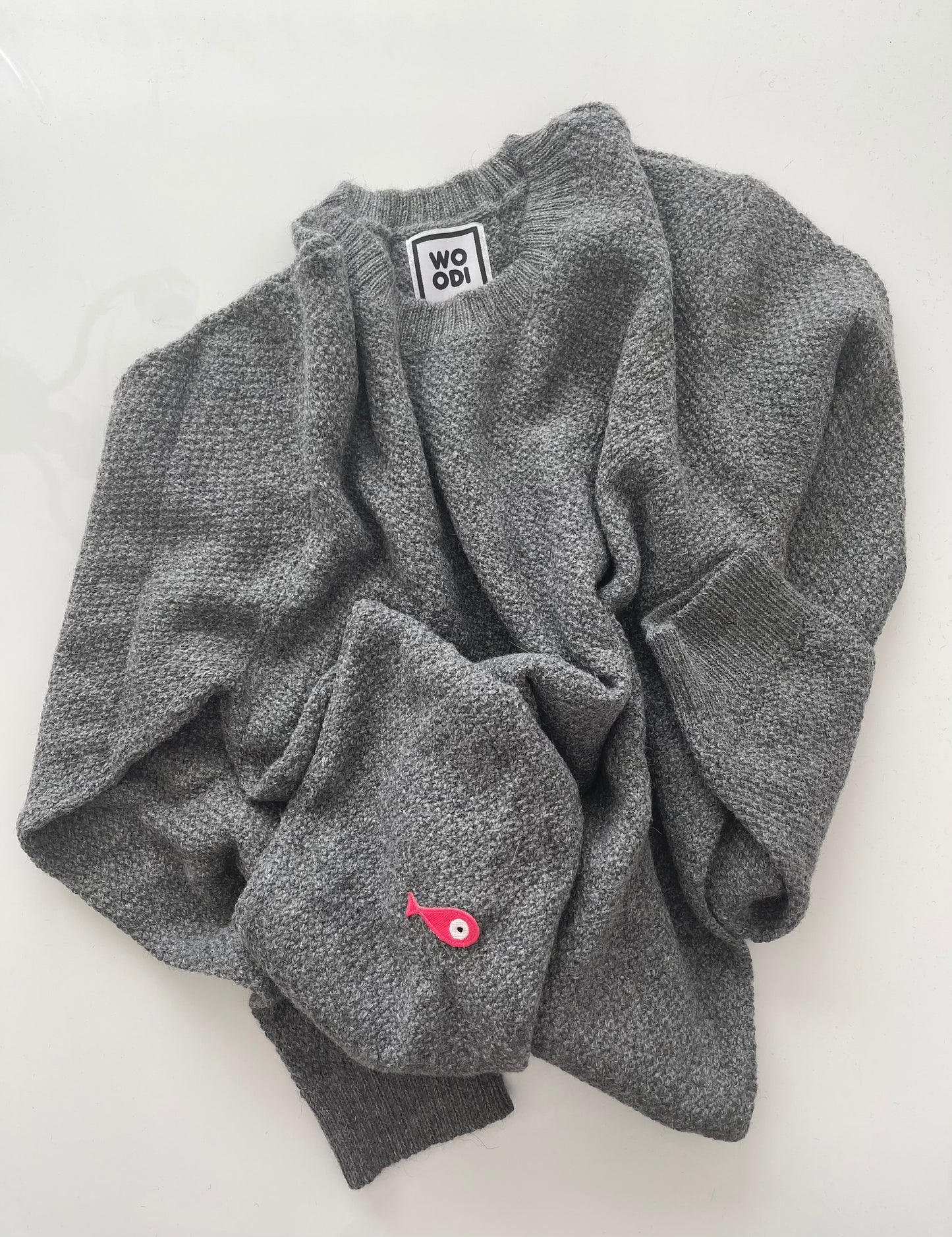 Soft, luxuriously cozy sweater. Knitted from fine alpaca yarn. Classic fit and a lovely feeling.  Colours : creme white, navy blue and grey  Patch: pink fish ( placed on the right bottom corner )  Material: 100% alpaca Front Smart casual dress code