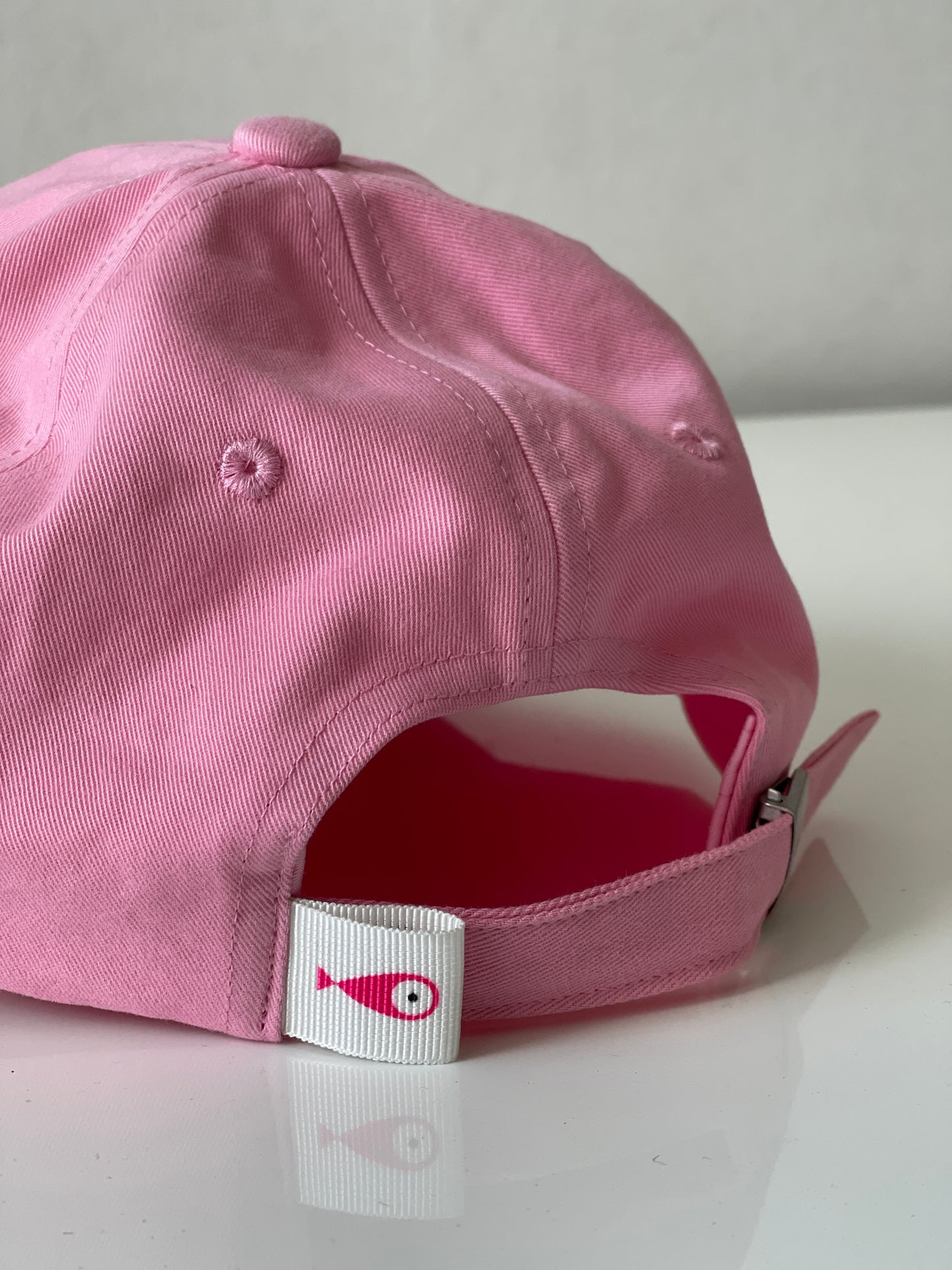 Cap Classic "Fish"  Slightly curved brim  Fish embroidery on front  Label on the back  Buckle to adjust the fit  5 Colors available : Navy Blue, Black, Pink, Olive Green and Light Beige  100 % cotton  One size Back Detail