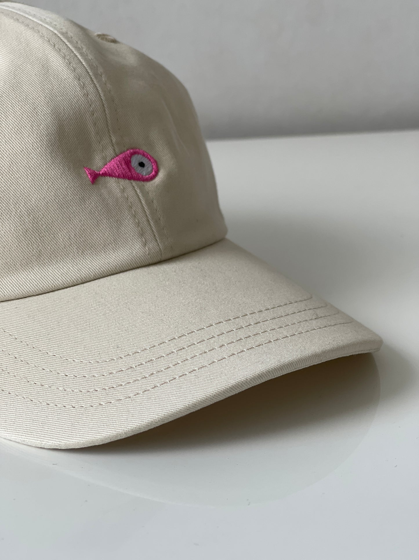 Cap Classic "Fish"  Slightly curved brim  Fish embroidery on front  Label on the back  Buckle to adjust the fit  5 Colors available : Navy Blue, Black, Pink, Olive Green and Light Beige  100 % cotton  One size Front Side