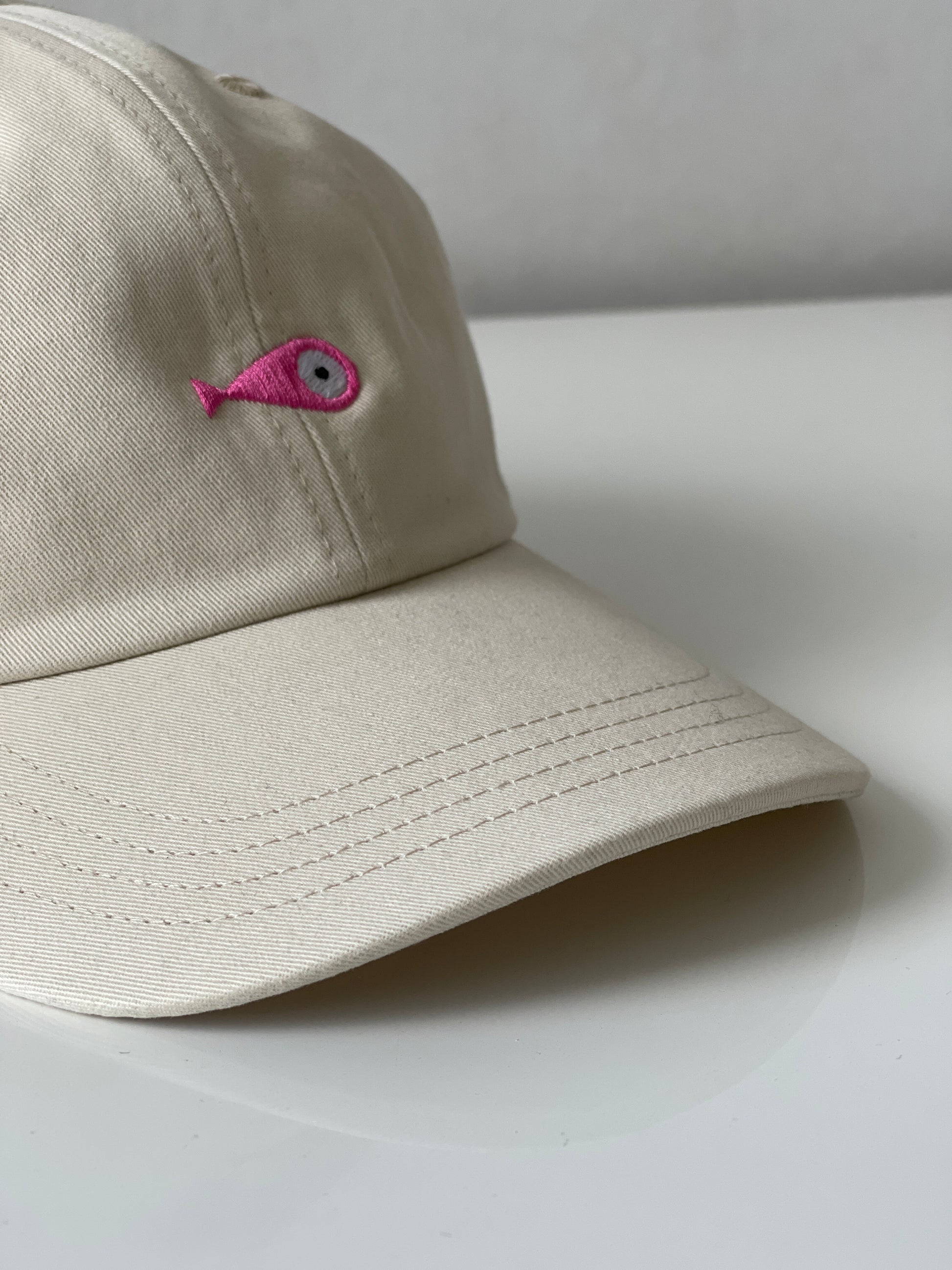 Cap Classic "Fish"  Slightly curved brim  Fish embroidery on front  Label on the back  Buckle to adjust the fit  5 Colors available : Navy Blue, Black, Pink, Olive Green and Light Beige  100 % cotton  One size Front Side