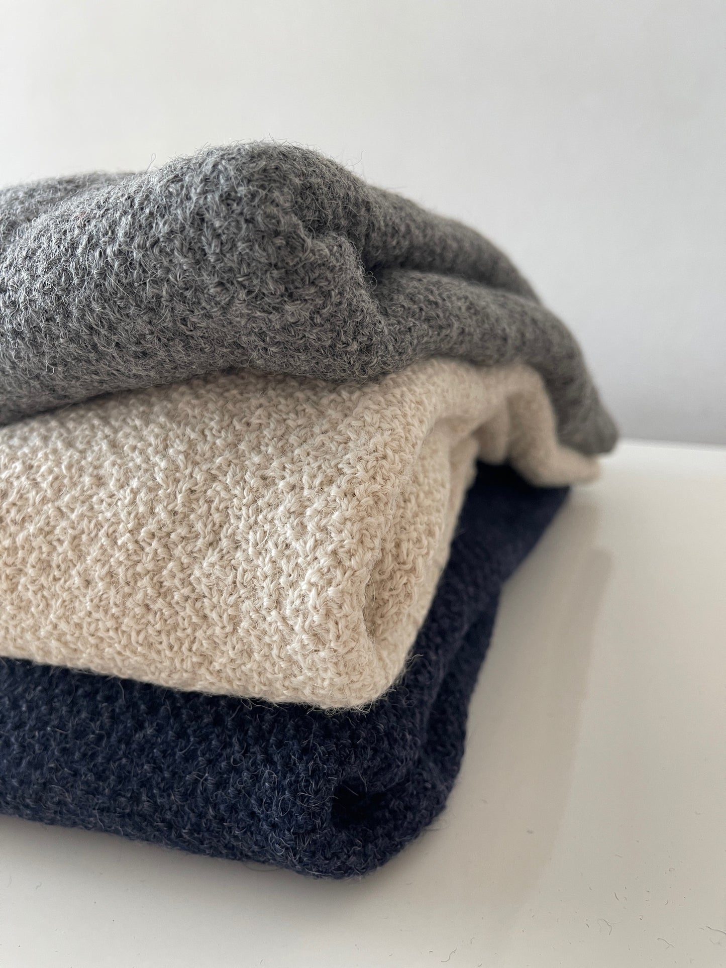 Soft, luxuriously cozy sweater. Knitted from fine alpaca yarn. Classic fit and a lovely feeling.  Colours : creme white, navy blue and grey  Patch: pink fish ( placed on the right bottom corner )  Material: 100% alpaca Detail Smart casual dress code