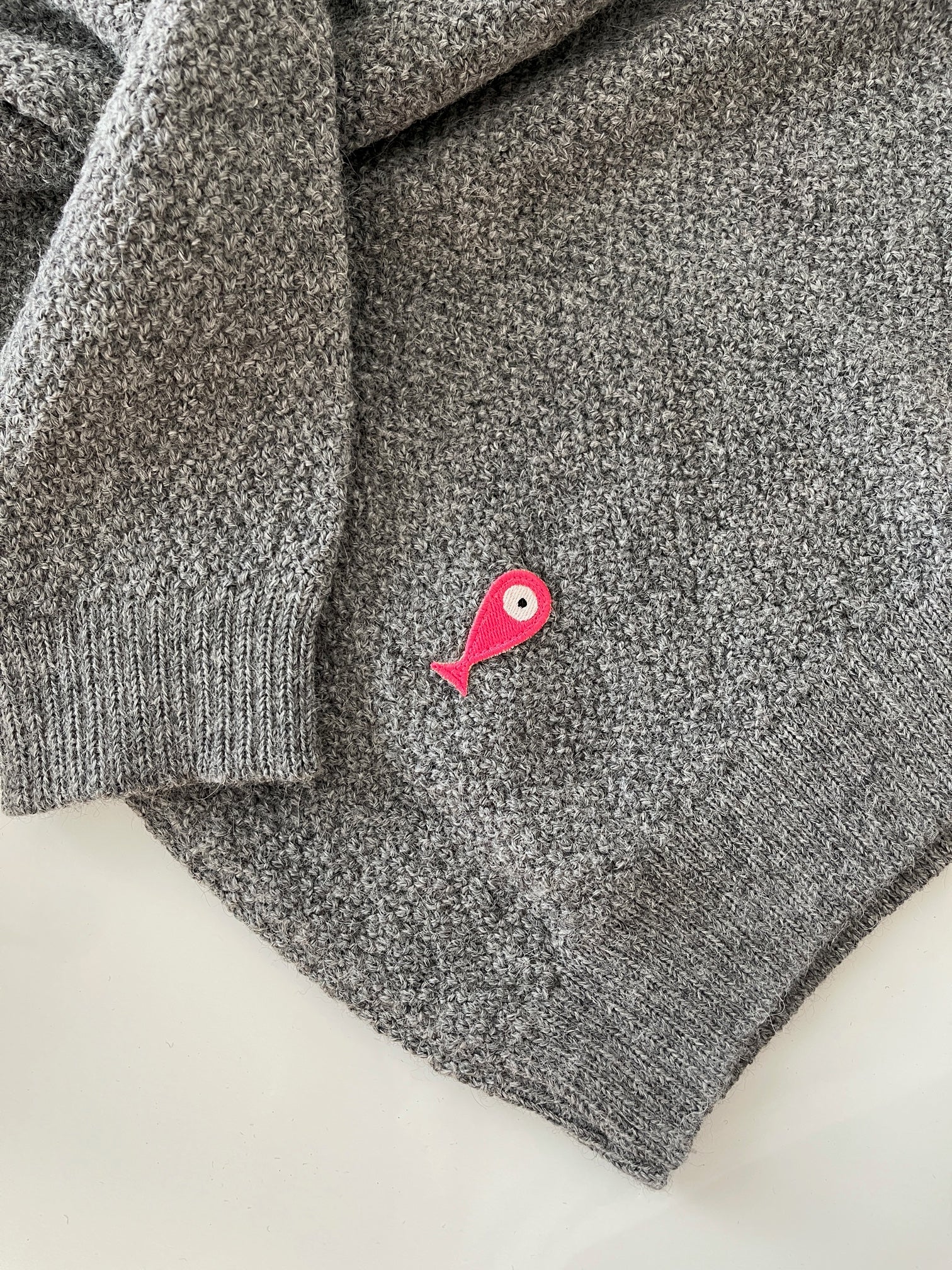 Soft, luxuriously cozy sweater. Knitted from fine alpaca yarn. Classic fit and a lovely feeling.  Colours : creme white, navy blue and grey  Patch: pink fish ( placed on the right bottom corner )  Material: 100% alpaca Detail smart casual dress code