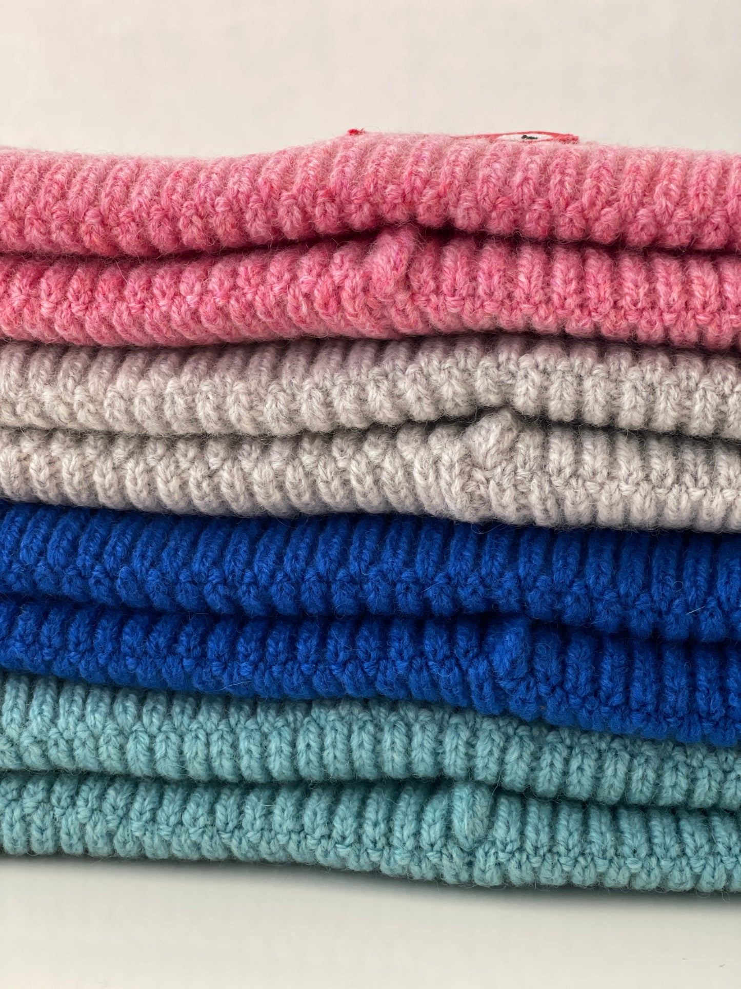 The collection of soft, colorful, and warm beanies crafted from luxurious lambswool yarn. Embrace comfort and style with these lovely accessories available in four captivating colors: Pink, Blue, Vibrant Mint, and Light Grey. Each beanie features a unique fish patch, adding a touch of charm and playfulness.  Detail